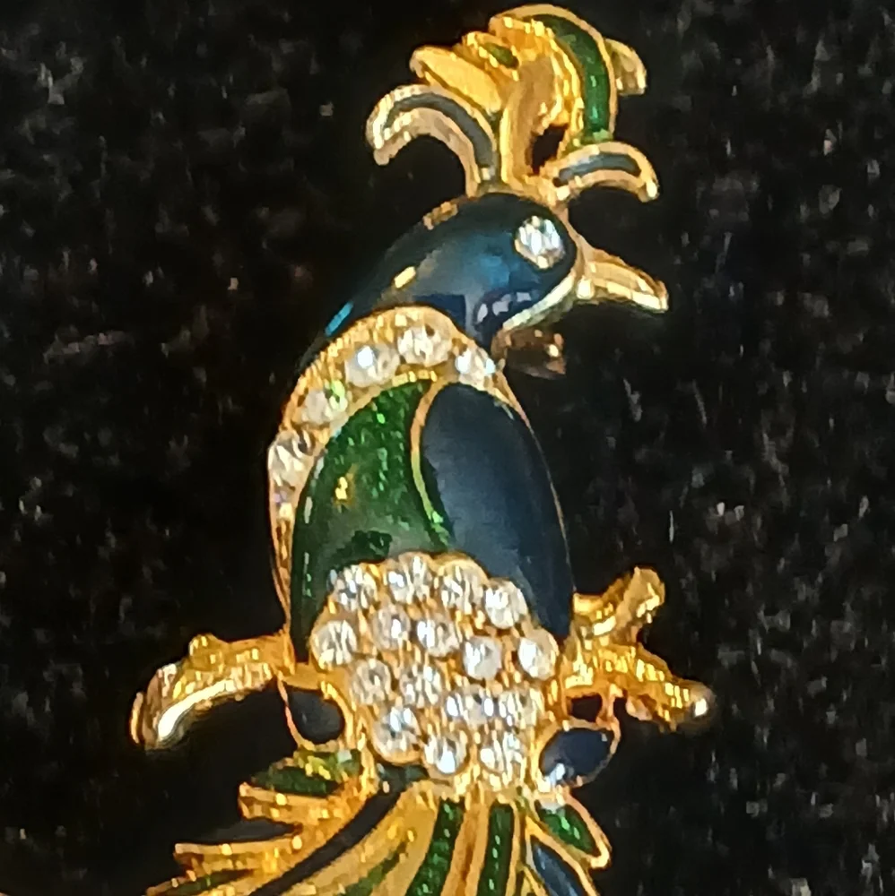 Goldtone peacock brooch with blue and green accents